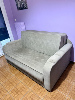 Two-seater sofa light brown/grey like new, folds into a bed
