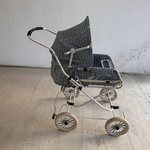 Vintage baby stroller with classic check fabric and metal frame