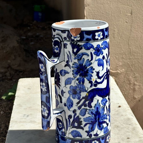 Vintage handmade ceramic cup and decorative Delft style jug used, blue floral