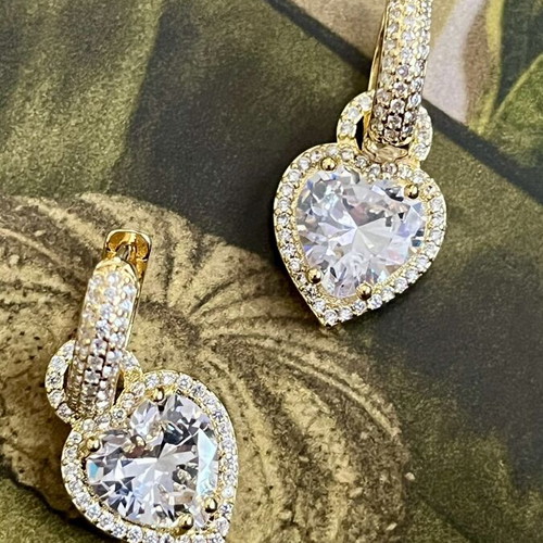 Gold-tone earrings with heart-shaped transparent stone and zircon details