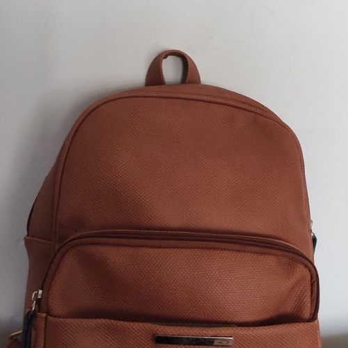 Back pack tan used with internal and external pockets