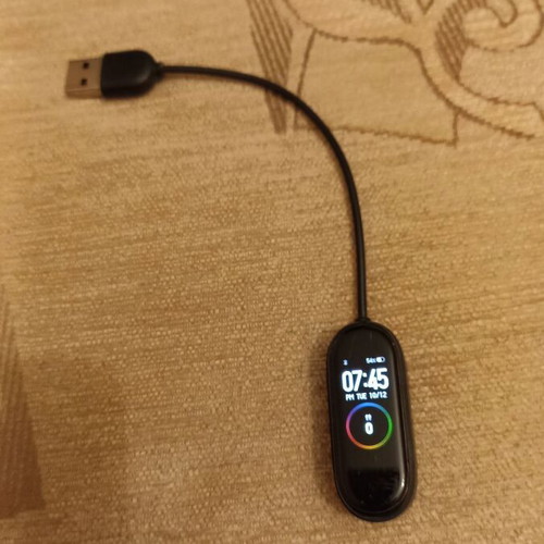 Mi Band smart watch used with charger, strap needs replacement