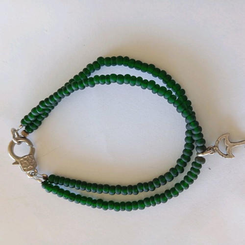 Handmade bracelet with green beads and silver umbrella charm