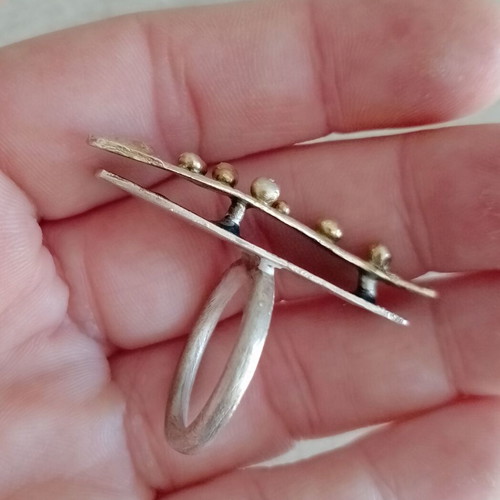 Statement two-tone ring used with layers, silver and gold colors