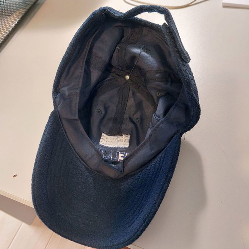 Fleece jockey hat like new, dark blue with national emblem