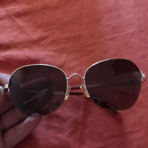 Sunglasses used with wear and gold arm