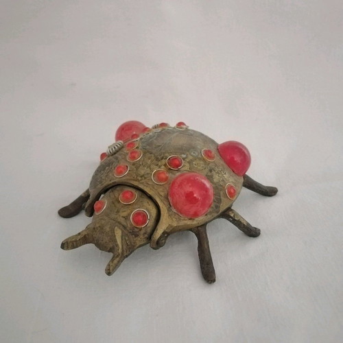 Bronze ashtray used with red scarab-shaped stones