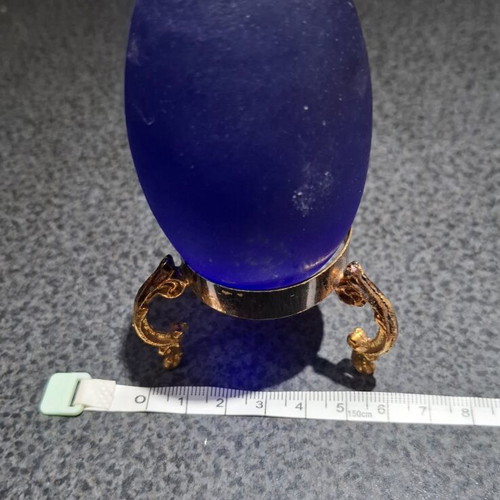 Vintage decorative crystal egg with blue matte glass and gold metal base used