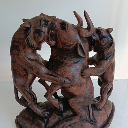 Hunting scene with buffalo and predators wood carving
