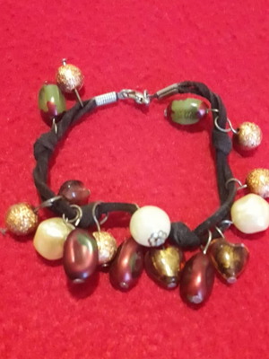 Bracelet with braided cord and dangling stones like new, black and gold
