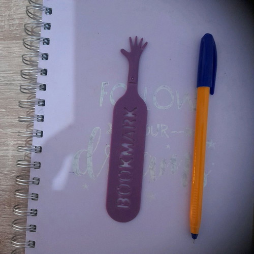Plastic bookmark used, hand shape