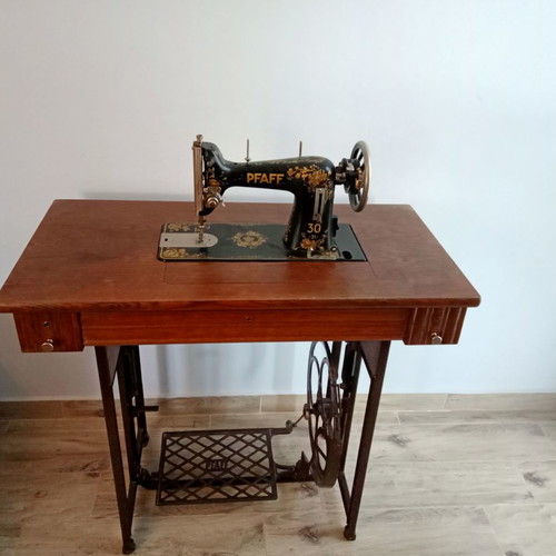 Antique sewing machine used with furniture and accessories