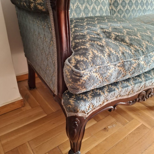 Vintage three-seater sofa and two antique armchairs with dark wood frame