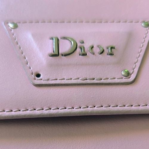 Dior wallet used, pink with slight wear and missing stud