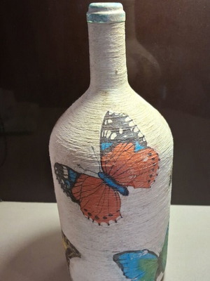 Decorative bottle with butterflies decoupage used, natural twine