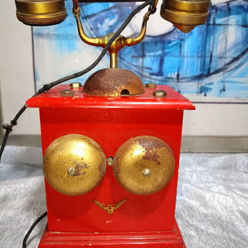 Vintage metal rotary phone, red with gold details