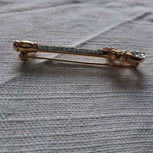 Metal key-shaped pin like new, multicolored, gold tone