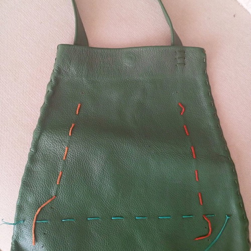 Handmade leather shoulder bag used in deep green boho style