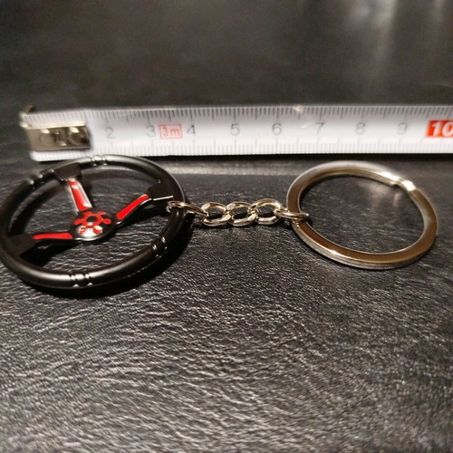 Metal car keychain new with sporting black red steering wheel design