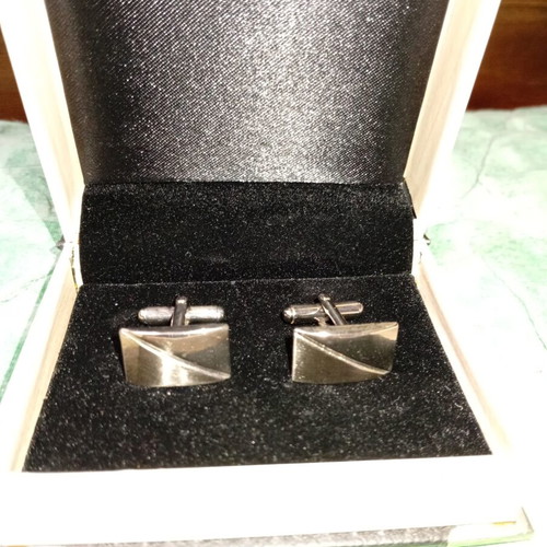 Silver cufflinks in book-style case
