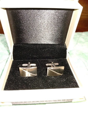 Silver cufflinks in book-style case