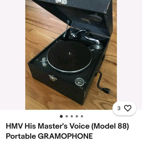His Master's Voice portable gramophone used with accessories