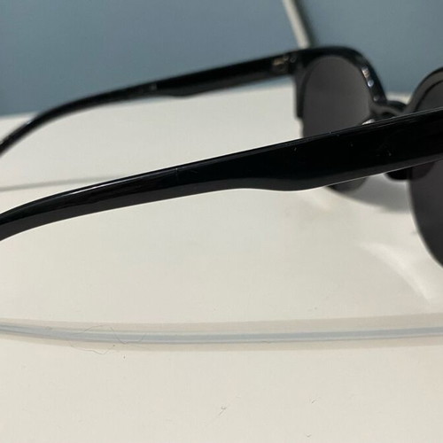 Sunglasses used with black frame and round shape