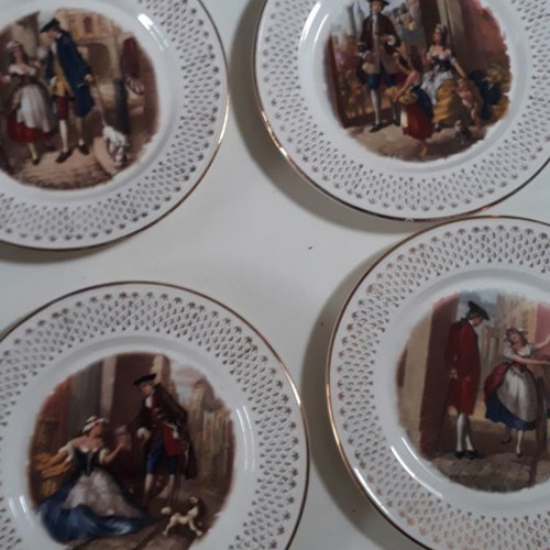 Set of four used French wall plates with gold designs 23cm