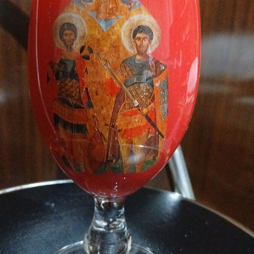 Red glass candlestick with double saints depiction, 17cm