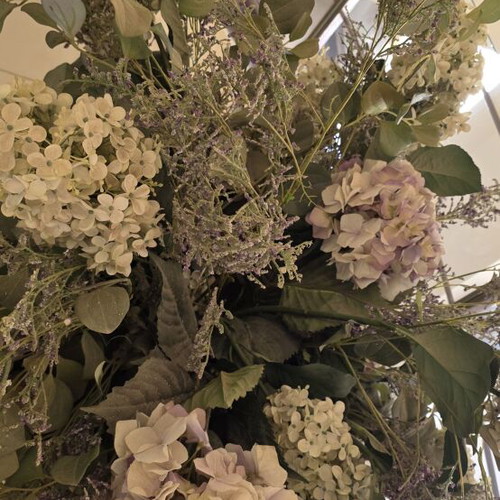 Artificial flower arrangement with hydrangeas and eucalyptus in clay floor vase