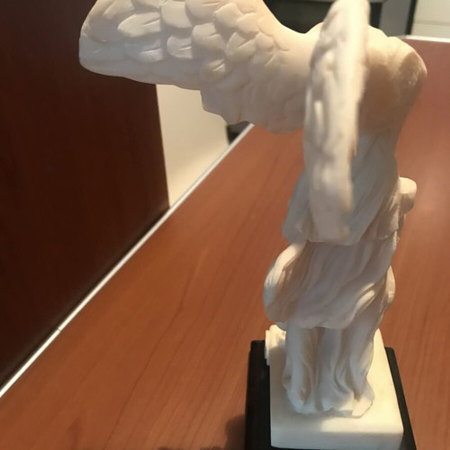 Nike of Samothrace alabaster figurine with minimal black base like new