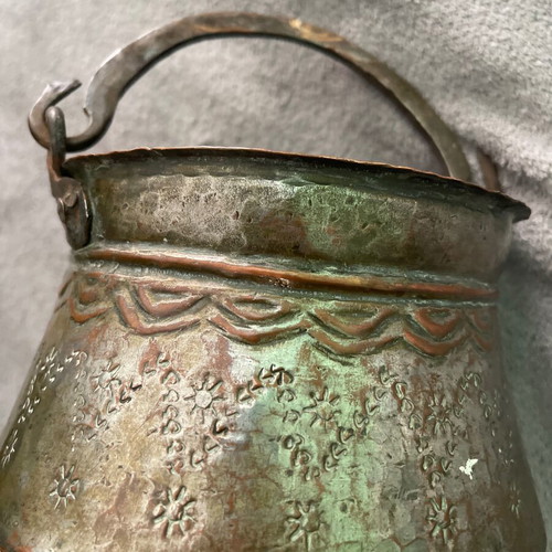 Handmade copper cauldron used with hammered texture and designs