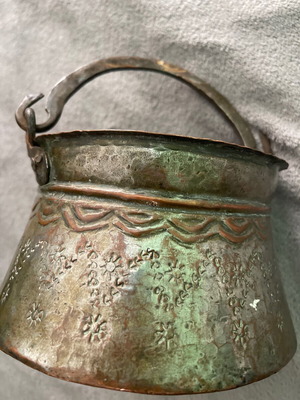 Handmade copper cauldron used with hammered texture and designs