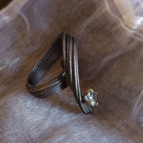 Handmade ring of oxidized silver with white topaz like new