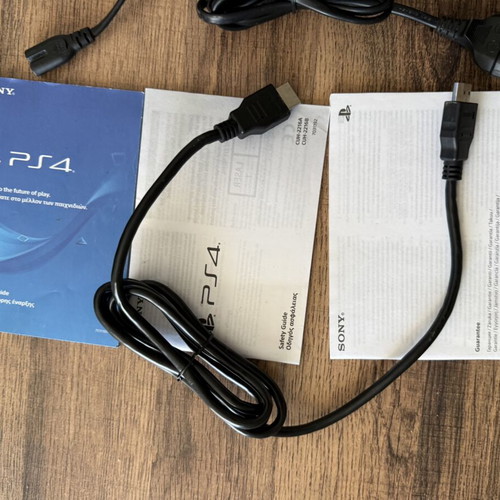 PlayStation 4 Slim 500GB used with 2 DualShock 4 controllers and accessories