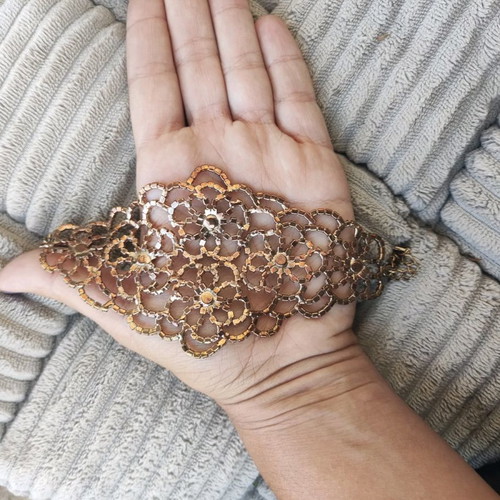 Evening bracelet with rhinestone flower motif like new, gold color