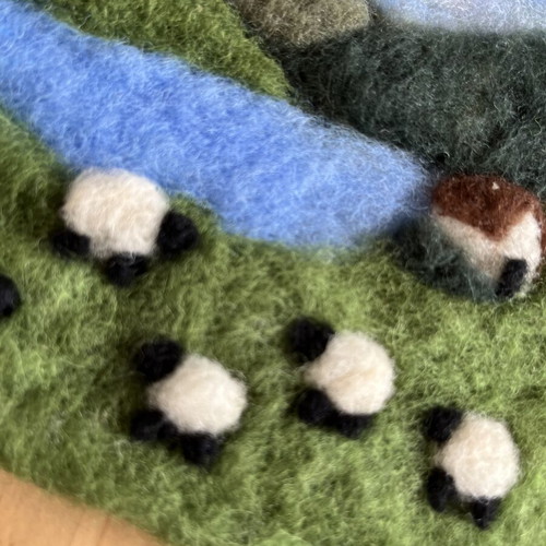 Handmade wool felt landscape picture with sheep