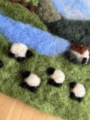 Handmade wool felt landscape picture with sheep