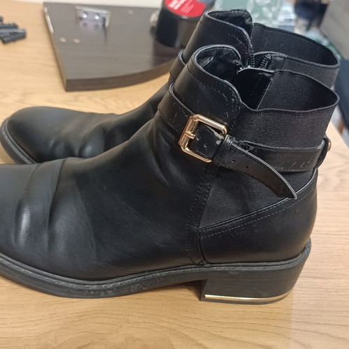 Black ankle Chelsea boots with buckle and gold details