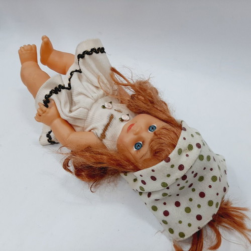 Vintage plastic doll 60s with open eyes, white knitted dress, tiara