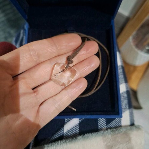 Swarovski necklace like new, transparent with brown cord