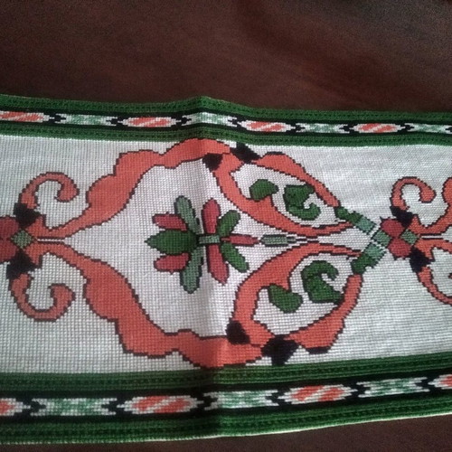 Handmade table runner with intricate crochet fringes and embroidery