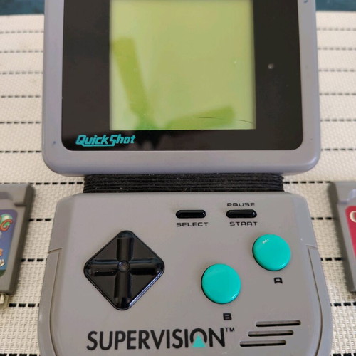 Watara Supervision console used with 3 games