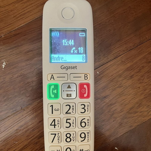 Cordless landline telephone with big numbers used, white