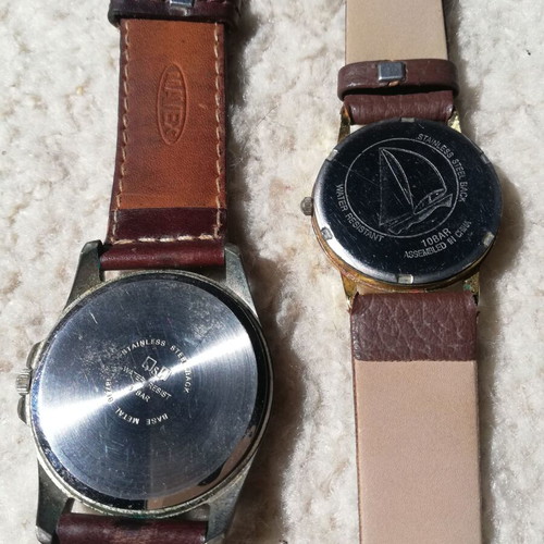 Q&Q wristwatches used with brown leather straps, blue one has glass damage
