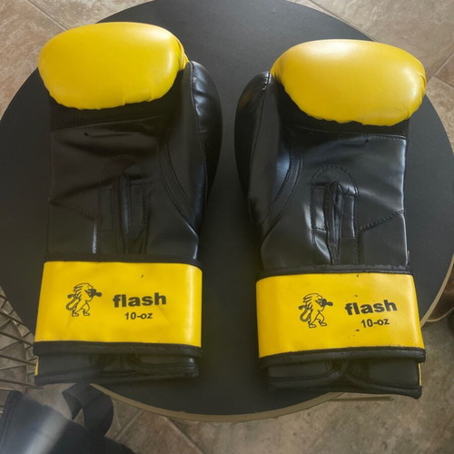 Kick boxing equipment used with gloves, wraps, shin guards, mouthguard, and bag