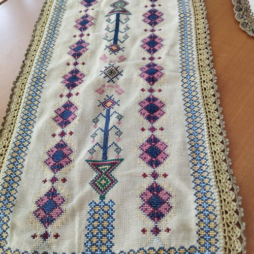 Vintage handmade embroidered table linens with cross-stitch and gold thread