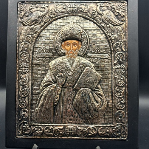 Silver embossed icon of Saint Nicholas used, with wooden base