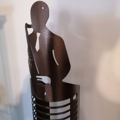 Metal CD holder like new with saxophone player design