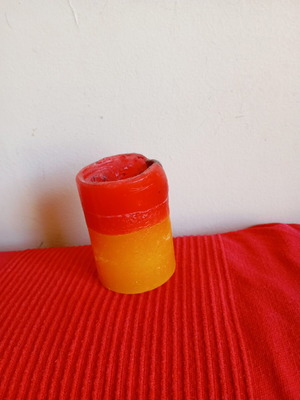 Two-tone decorative candle used red orange